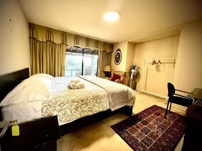 a bedroom with a bed with two towels on it at Cozy and spacious room near UBC-2 in Vancouver