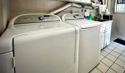 a white washer and dryer in a kitchen at Cozy and spacious room near UBC-2 in Vancouver