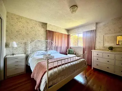 a bedroom with a bed and a window at Cozy and spacious room near UBC-2 in Vancouver