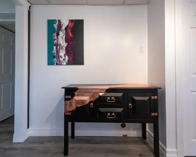 a desk in a room with a painting on the wall at Magical Themed Decor! Pets Welcome! 3 Bedrooms in Chase