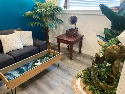 a living room with a couch and a fish tank at Magical Themed Decor! Pets Welcome! 3 Bedrooms in Chase