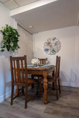 a dining room with a wooden table and two chairs at Magical Themed Decor! Pets Welcome! 3 Bedrooms in Chase