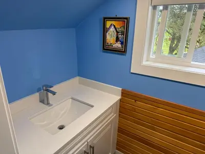 a bathroom with a white sink and a window at Sunshine garden 3 bedrooms2 bathrooms1 living room1 kitchen in Aldergrove