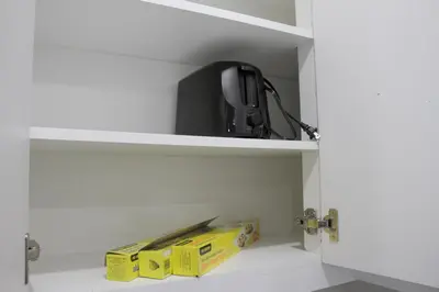 a white cabinet with a box and a router at Modern 2 Beds 1 Bath Private Suite, Close to mountains in Calgary