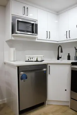 a kitchen with a microwave and a dishwasher at Modern 2 Beds 1 Bath Private Suite, Close to mountains in Calgary