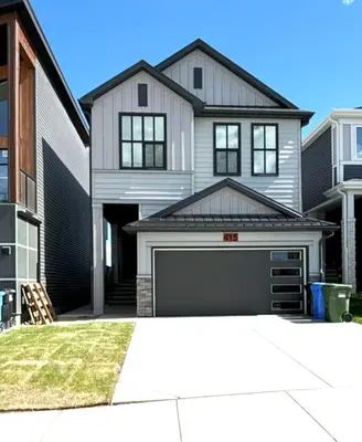 a large white house with a garage at Modern 2 Beds 1 Bath Private Suite, Close to mountains in Calgary