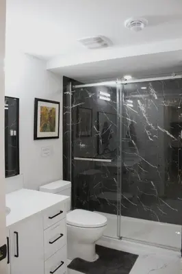 a bathroom with a toilet and a glass shower at Modern 2 Beds 1 Bath Private Suite, Close to mountains in Calgary
