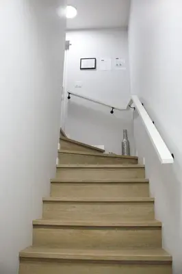 a staircase in a house with white walls and wooden floors at Modern 2 Beds 1 Bath Private Suite, Close to mountains in Calgary