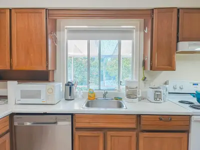 a kitchen with a sink and a window at Cozy Airb&b Suite in South Vancouver in Vancouver