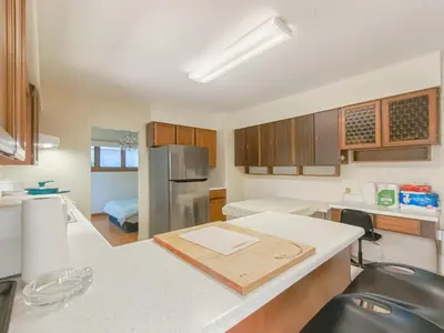 a kitchen with a wooden cutting board on a counter at Cozy Airb&b Suite in South Vancouver in Vancouver