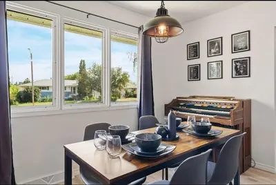 a dining room with a table and chairs and a window at The Coal Stone throw away from Red Deer River 2BR House in Drumheller