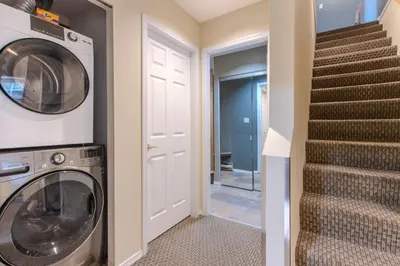 a laundry room with a washer and dryer at The Snowbird by Whiski Jack in Whistler