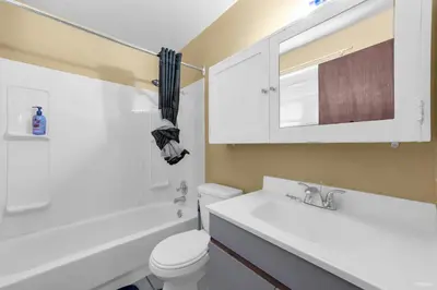 a bathroom with a toilet and a sink and a mirror at Cozy Airb&b Guest Suite Near Metrotown in Burnaby