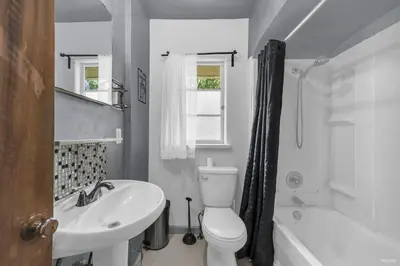 a bathroom with a white toilet and a sink at Cozy Airb&b Guest Suite Near Metrotown in Burnaby