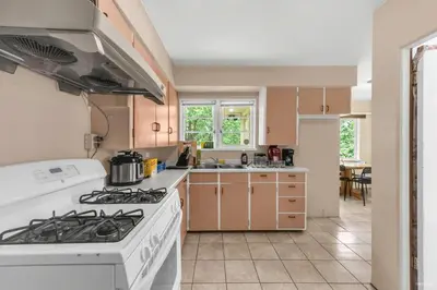 a kitchen with a white stove top oven at Cozy Airb&b Guest Suite Near Metrotown in Burnaby