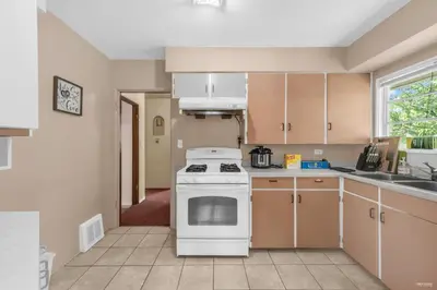 a kitchen with a white stove top oven at Cozy Airb&b Guest Suite Near Metrotown in Burnaby