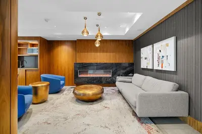 a living room with a couch and a fireplace at Luxury Waterfront Suite with City Views and AC in Calgary