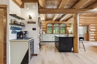 a kitchen with wooden ceilings and a wooden floor at Nordegg Timber Estate in Nordegg