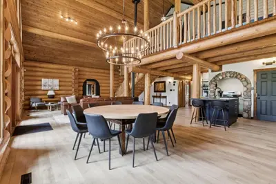 a dining room and living room with a table and chairs at Nordegg Timber Estate in Nordegg