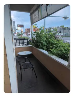 a table and a chair sitting on a balcony at Tania's guest rooms in Calgary