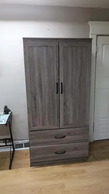 a wooden cabinet in the corner of a room at Tania's guest rooms in Calgary