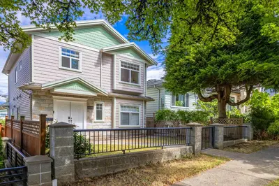 a house with a fence in front of it at Central Spacious 3 Br Upstairs in Vancouver