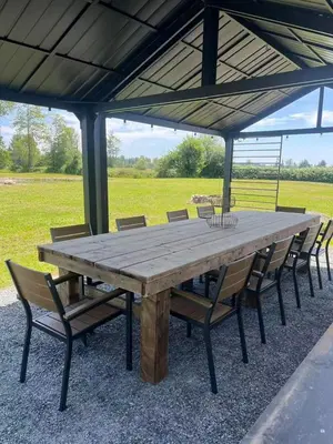 a large wooden table with chairs under a pavilion at Sunshine garden 5 bedrooms2 living rooms3 bathrooms1 kitchen in Aldergrove