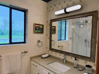 a bathroom with a sink and a large mirror at Sunshine garden 5 bedrooms2 living rooms3 bathrooms1 kitchen in Aldergrove