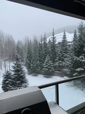 a view of a snow covered yard from a window at XL Luxury Penthouse Ski-in Ski-out The Aspens in Whistler