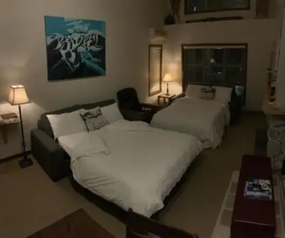 a hotel room with two beds and a couch at XL Luxury Penthouse Ski-in Ski-out The Aspens in Whistler