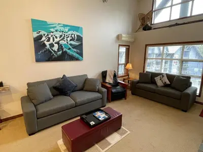 a living room with two couches and a table at XL Luxury Penthouse Ski-in Ski-out The Aspens in Whistler