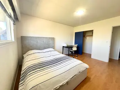 a bedroom with a bed and a desk in it at Cozy 3 Bedrooms with Kitchen and Laundry Near Airport in Richmond
