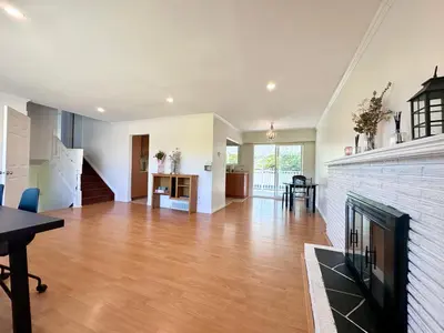 a living room with a fireplace and a dining room at Cozy 3 Bedrooms with Kitchen and Laundry Near Airport in Richmond