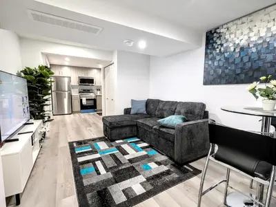 a living room with a couch and a table at Basement Suite in Desrochers SW in Edmonton