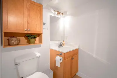a bathroom with a white toilet and a sink at Prestigious 2 Bedrooms 2 Baths in West Point Grey in Vancouver