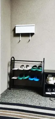 a shelf with shoes on it next to a wall at Eagle's House, Room #1 in Victoria