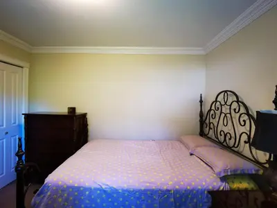 a bedroom with a bed and a dresser in it at Eagle's House, Room #2 in Victoria