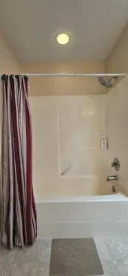 a white bath tub in a room at Eagle's House, Room #2 in Victoria