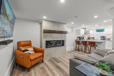 a living room with a couch and a fireplace at Blue Spruce Den - Vernon in Vernon