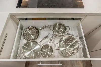 a glass cabinet with four silver utensils in it at Blue Spruce Den - Vernon in Vernon