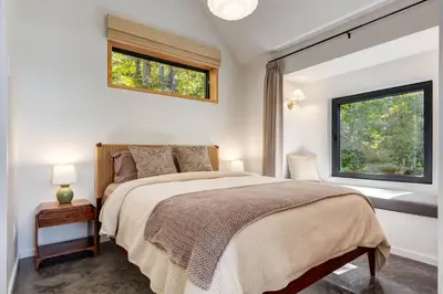 a bedroom with a bed and a window at Fogged Inn in Ucluelet