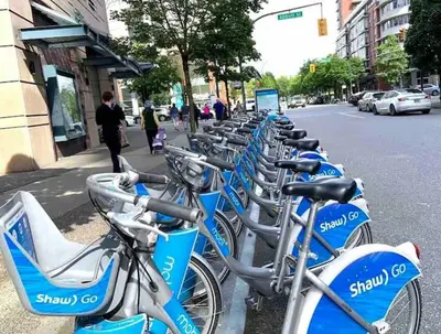 a row of blue bikes parked on the side of a street at Downtown,FreeParking,Pool,Comfy,OceanMontain View in Vancouver