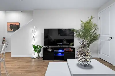 a living room with a vase sitting on a table at Cozy 2BR Suite with Kitchen, AC Near U of C, Winsport, Banff and Hospitals in Calgary