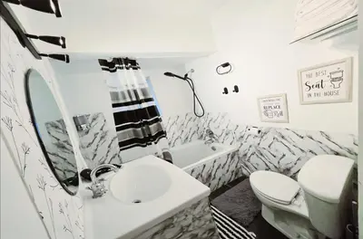 a white bathroom with a sink and a toilet at Private 2 BR Cozy Home Private Parking Free Sparkling and Goodies! 4 mins from Metrotown in Burnaby