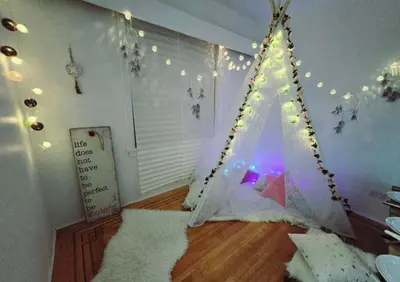 a room with a bed with a tent in it at Private 2 BR Cozy Home Private Parking Free Sparkling and Goodies! 4 mins from Metrotown in Burnaby
