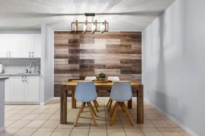 a dining room with a wooden table and two chairs at Cozy & Spacious 2BR in Downtown very close to Stampede and 17th Ave with Parking and AC in Calgary