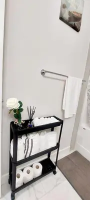 a bathroom with a towel rack with towels at Little Heaven 2BR southwest Calgary in Calgary