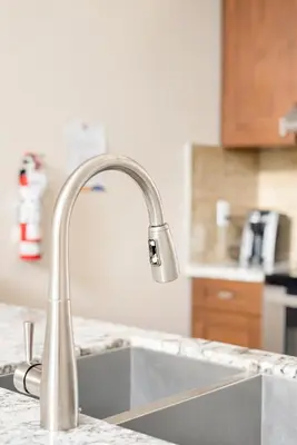 a kitchen sink with a faucet on a counter at Harrison 3BR Pet friendly Unit in Harrison Hot Springs