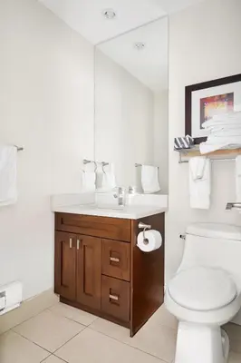 a bathroom with a sink and a toilet and a mirror at Scenic 3BR unit in Harrison in Harrison Hot Springs