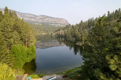 a view of a lake in the middle of a forest at Mountain Springs Nature Retreat in Kaleden